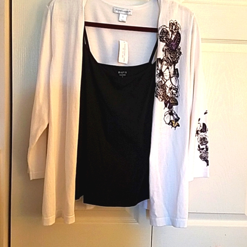 White sweater with black floral trim and black camisole